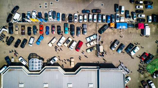 Many vehicles parked near a building